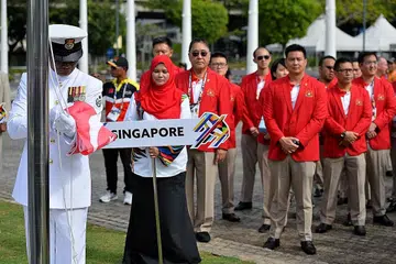 BENDERA DIKIBAR: Kontinjen Singapura di upacara mengibarkan bendera negara peserta Sukan SEA ke-29 di Stadium Bukit Jalil, Kuala Lumpur. - Foto FAKHRURADZI ISMAIL