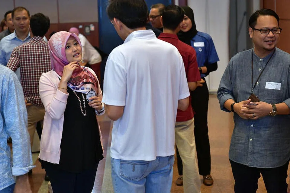 Cik Rahayu Mahzam (bertudung merah jambu) berinteraksi dengan hadirin di pelan kerja rangkaian M Kuasa Tiga (M³)@Bandar Jurong pagi tadi. FOTO: NG SOR LUAN