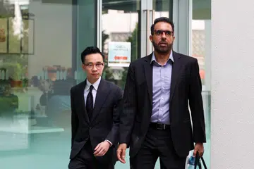 Ketua Pembangkang yang juga Ketua Parti Pekerja (WP), Encik Pritam Singh (kanan), meninggalkan Mahkamah Negara pada 22 Oktober, bersama salah seorang peguamnya, Encik Aristotle Emmanuel Eng Zhen Yang.