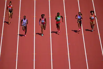 PERSAINGAN SENGIT: Pelari pecut Singapura Shanti Pereira (dua dari kanan) tewas kepada Jael Bestue (kanan) dari Sepanyol, yang mendapat tempat ketiga, dalam pusingan saringan 100 meter mereka di Kejohanan Olahraga Dunia pada Ahad. 