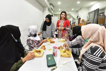 SUASANA KEKELUARGAAN TERASA: Pembantu rumah di rumah perlindungan Home yang dirujuk ke situ menyusuli aduan didera atau disalah guna majikan berpeluang menikmati ukhuwah pihak pengurusan seperti anggota Lembaga Pengarah Home, Cik Linda Ma'arof (berdiri di kiri) dan Pemangku Pengarah Eksekutif Home, Cik Deshi Gill (berdiri, kanan). - Foto BM oleh DESMOND WEE