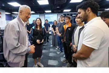 Menteri Kanan Encik Lee Hsien Loong (kiri) bertemu dengan sekumpulan pasukan muda daripada Kumpulan Keselamatan Siber GovTech.  Menurutnya beliau berasa amat menggalakkan melihat semangat dan komitmen mereka dalam membina Singapura digital yang lebih selamat dan terjamin.