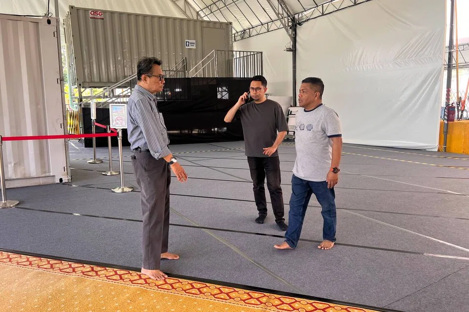 Encik Nassir Siraj (kiri) bersama kakitangan masjid, Encik Hadisyafiq Mohd Salleh (tengah), dan Encik Ahmad Syed Ali, memastikan keselamatan di ruang solat sementara Masjid Alkaff Kampung Melayu sentiasa terjaga.