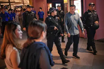 TINGKAT RONDAAN: Encik Amrin bersama Pegawai Pasukan Tindak Balas 'In Situ' (IRT) yang sedang menjalankan rondaan di Clarke Quay.