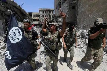 RAIKAN KEMENANGAN: Askar Iraq membawa bendera IS yang dirampas selepas mereka menawan sebahagian bandar Mosul semalam. - Foto REUTERS