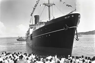 UCAP SELAMAT: Keluarga-keluarga para jemaah haji menghantar jemaah berlepas dari Singapura dalam foto yang diambil pada 1954. - Foto ARKIB NEGARA