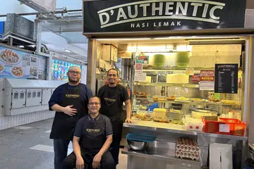 RESIPI IBU: Pemilik gerai, Encik Sulaiman Abu (tengah) telah mempelajari cara memasak nasi lemak daripada ibunya sejak kecil. Bersama dalam gambar adalah anak angkat Encik Sulaiman, Encik Muhammad Taufiq Mohd Zainordin (kiri) dan menantu Encik Sulaiman, Encik Mohamad Zulfadhli Refa’ie Mohamad Refa’ie.