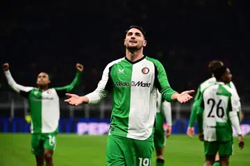 Penyerang Feyenoord, Julian Carranza (tengah) meraikan jaringannya ketika menentang AC Milan dalam aksi kedua playoff Liga Juara-Juara Eropah di Stadium San Siro.