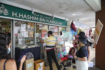 KEDAI BUKU TERTUA: Kedai buku Haji Hashim yang terletak di Joo Chiat Complex merupakan salah satu kedai yang dipaparkan sebahagian Jejak Geylang Serai yang baru dilancarkan. Kedai buku itu bakal menyambut ulang tahun ke-100-nya tahun depan. - Foto BH oleh KEVIN LIM