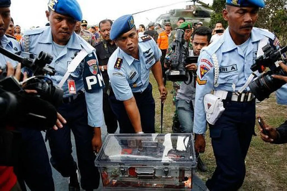 BERJAYA DITEMUI: Perakam data penerbangan pesawat QZ8501 dibawa polis tentera Indonesia di pangkalan tentera udara di Pangkalan Buni, Kalimantan tengah semalam. - Foto REUTERS
