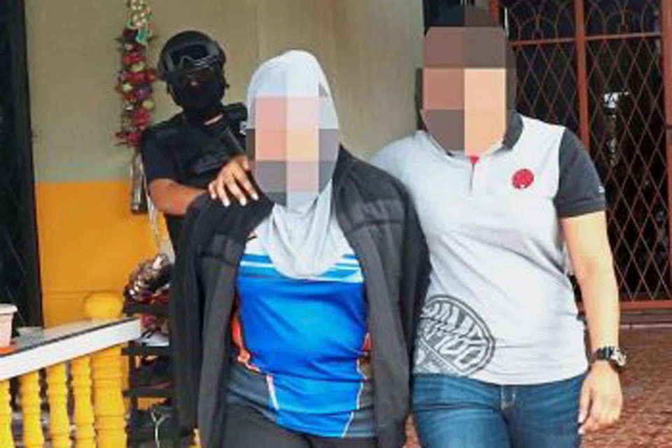 KEGIATAN MILITAN: Pegawai imigresen wanita (kiri) yang ditahan di Lapangan Terbang Sandakan kerana menerima bayaran bagi membantu menjamin laluan selamat untuk anggota militan dari Indonesia dan Filipina. - Foto THE STAR