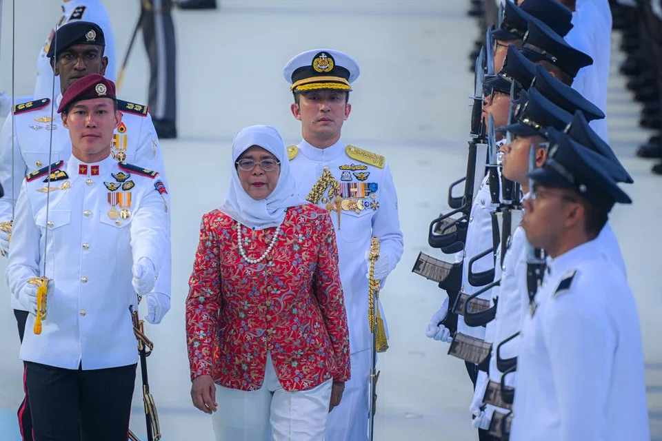 PERIKSA KAWALAN KEHORMATAN: Presiden Halimah Yacob kelihatan memeriksa kawalan kehormatan semasa Perbarisan Hari Kebangsaan pada Rabu.