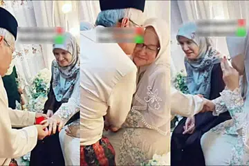 BERTEMU KEMBALI: Encik Abdullah (kiri) menyarungkan cincin ke jari Cik Zabidah pada majlis pernikahan mereka pada 28 Oktober lalu. 