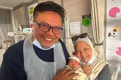 Selebriti Suhaimi Yusof (kiri) dan isterinya, Cik Siti Yuhana Sulaiman (kanan), bergambar bersama cucu pertamnya, Akiff Muaz Amirul, pada 21 Julai.