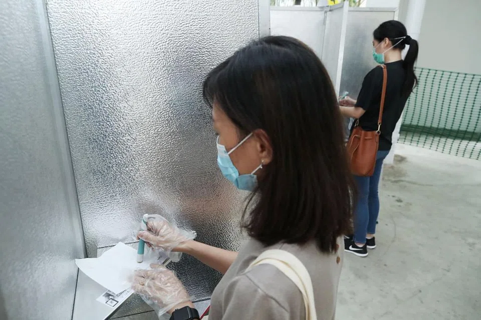 MENCUBA PENA MENGUNDI: Pastikan pena untuk mengundi tidak bermasalah. Pena akan dibersihkan oleh pegawai setiap 30 minit dengan menggunakan sanitiser bermakna proses mengundi akan dihentikan setiap 30 minit.