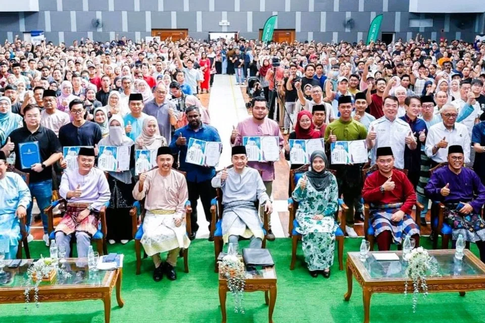 Menteri Besar Johor, Datuk Onn Hafiz Ghazi (tengah) bersama penerima-penerima Sijil Layak Menduduki Rumah Mampu Milik Johor di Johor Bahru.