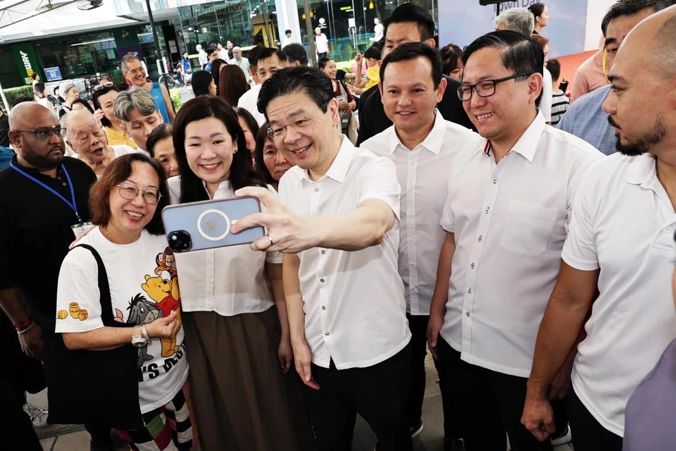 Anggota Parlimen (AP) GRC Marsiling-Yew Tee (dari kanan) Encik Alex Yam; Menteri Negara Kanan (Pertahanan merangkap Tenaga Manusia), Encik Zaqy Mohamad; Perdana Menteri, Encik Lawrence Wong; Cik Hany Soh, beramah tamah dengan hadirin di pelancaran Pelan Induk Majlis Bandaran Marsiling-Yew Tee (2025-2030), di Yew Tee Square pada 5 April. 