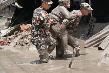 Anggota tentera Nepal memindahkan seorang mangsa yang terselamat susulan banjir kilat dan tanah runtuh berhampiran sempadan Nepal-Tibet, dalam gambar yang diperoleh pada 27 Ogos. Bencana itu memusnahkan rumah, jalan raya dan jambatan dalam masa beberapa minit, menyebabkan ratusan orang terkorban dan ramai lagi masih hilang.