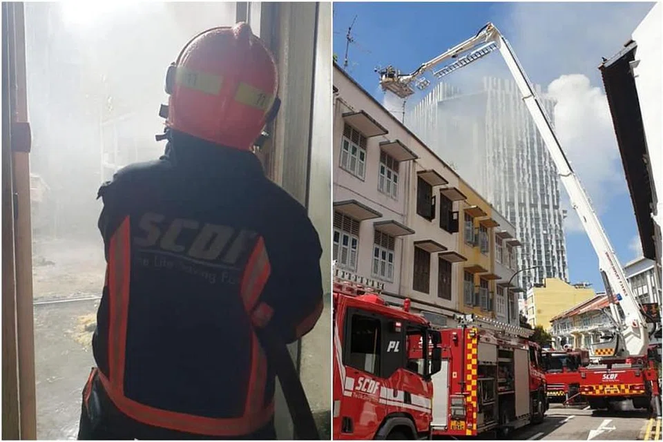 Pegawai SCDF cuba memadamkan api di rumah kedai di 31 Teo Hong Road di Outram Park pada 15 Jun 2021. - Foto-foto FACEBOOK/SINGAPORE CIVIL DEFENCE FORCE