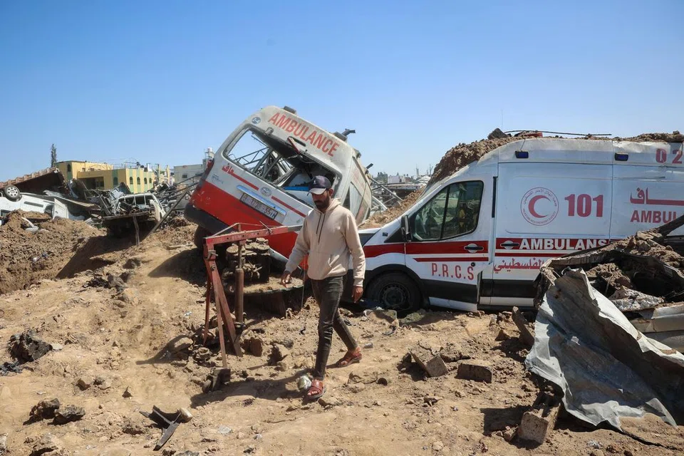 Seorang lelaki Palestin memeriksa kerosakan di kawasan membaiki ambulans yang terjejas dek serangan udara Israel di kem pelarian al-Maghazi, Gaza Tengah, pada 24 Mac.