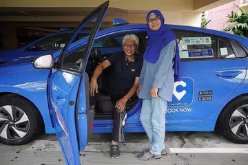 YAKIN BADAI AKAN BERLALU: Dengan keadaan pulih perlahan-lahan, pasangan pemandu teksi Encik Alias dan Cik Saadiah terus berusaha keras mencari rezeki dan berharap Covid-19 akan berlalu. - Foto BH oleh JASON QUAH