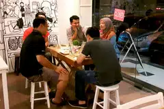 TAWAR PROMOSI: Cik Nur Farhana (kanan) bersama pelanggan warga Singapura, menyediakan rebat kepada pelanggannya bagi memastikan kehadiran terus warga Singapura ke Pink Daisy Bakery and Cafe di Taman Perling. - Foto PINK DAISY BAKERY AND CAFE