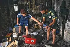 MUSNAH: (Gambar atas) Encik Muhammad Huzaimi Zuraimi, 22 tahun dan abangnya, Encik Muhammad Haiqal Zuraimi, 23 cuba cari barangan yang boleh diselamatkan setelah flat dua bilik mereka di Whampoa musnah. - Foto BH oleh DESMOND WEE