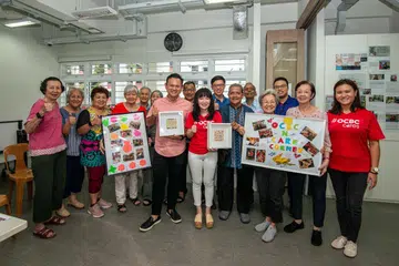 AKTIVITI PENUAAN AKTIF: Menteri Negara Kanan (Pertahanan merangkap Tenaga Manusia) dan Anggota Parlimen GRC Marsiling-Yew Tee, Encik Zaqy Mohamad (barisan depan, lima dari kiri), Ketua Jenama dan Komunikasi Kumpulan OCBC, Cik Koh Ching Ching, (di kirinya) bergambar bersama peserta di Pusat Penuaan Aktif Care Corner Singapura di Marsiling pada Rabu.
