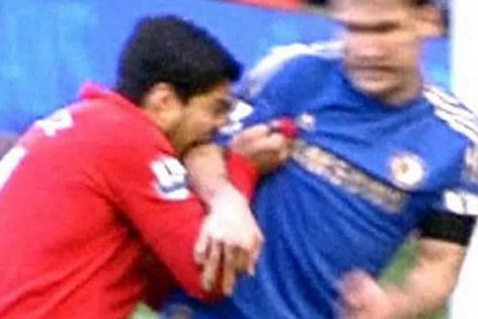 BUKAN KESALAHAN PERTAMA: Luis Suarez pernah dihukum kerana menggigit pemain Chelsea, Branislav Ivanovic, pada April 2013, kesalahan keduanya. - Foto DAILYMAIL.COM