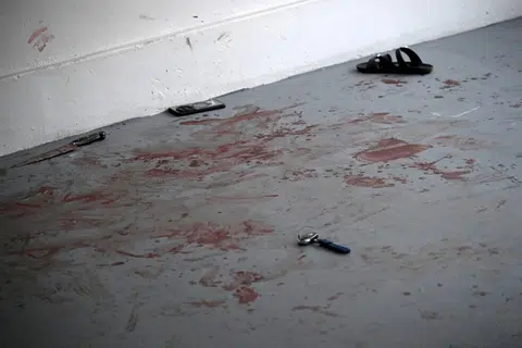 Sebilah pisau, jam tangan, telefon bimbit, kunci kereta dan selipar dilihat di lantai yang berlumuran darah.
