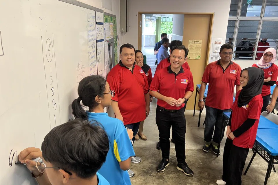 TINJAU PROGRAM: Menteri Negara Kanan (Pertahanan merangkap Tenaga Manusia), Encik Zaqy Mohamad (empat dari kanan), yang juga Timbalan Pengerusi Yayasan Mendaki, meninjau kelas pertama Program Tuisyen Mendaki (MTP) bagi pelajar Menengah 2 di Sekolah Menengah Tampines pada 20 Januari.