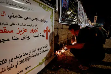 BERSIMPATI: Para penganut Kristian menyalakan  lilin tanda simpati kepada para mangsa kebakaran majlis perkahwinan di bandar Hamdaniya, Iraq, pada Sabtu,