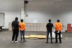 PADAH ELAK CUKAI: Dua lelaki ini (berpakaian oren) ditangkap dan 3,550 karton rokok tidak dibayar cukai serta sebuah trak dan sebuah van yang digunakan dalam kegiatan melibatkan barang elak cukai dirampas Kastam Singapura dalam satu operasi pada 2 Februari. - 