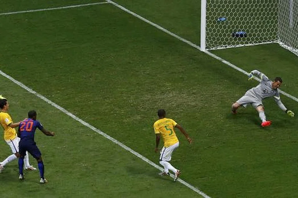 3-0: Penjaga gawang Julio Cesar gagal menyelamatkan percubaan Georginio Wijnaldum (jersi biru gelap) yang masih mampu mencari ruang di antara pemain bek Brazil untuk menjaringkan gol ketiga. - Foto REUTERS