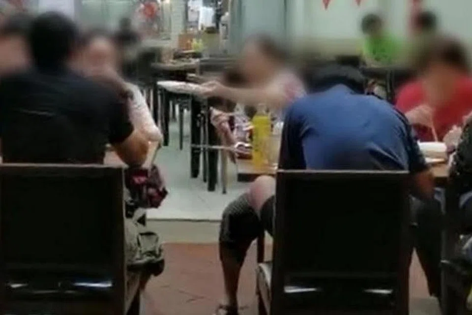 Sekumpulan tujuh pelanggan bergaul dan berkongsi makanan dan minuman di dua meja di sebuah kedai F&B di Chinatown pada 13 September 2020. 