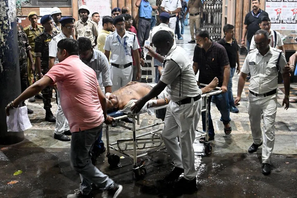 Petugas perubatan dilihat membawa mangsa yang cedera menggunakan pengusung, termasuk seorang pegawai polis, ke Kolej Perubatan dan Hospital Calcutta, di Kolkata, pada 17 Oktober.