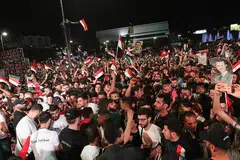 RAI KEMENANGAN: Penyokong Presiden Syria, Encik Bashar al-Assad, meraikan kemenangannya untuk penggal keempat, semalam. - Foto EPA-EFE