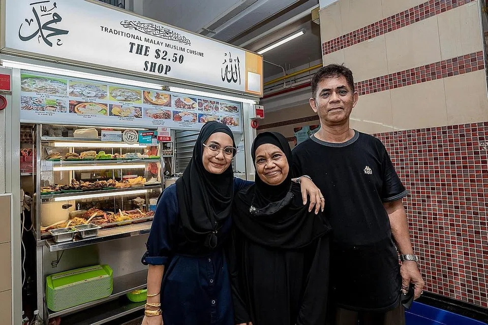 INGIN BANTU GOLONGAN MEMERLUKAN: Cik Hani Isnin bersama ibu bapanya Cik Munah dan Encik Isnin di depan gerai mereka yang terletak di Pusat Makanan Jalan Kukoh. - Foto-foto BM oleh NUR DIYANA TAHA