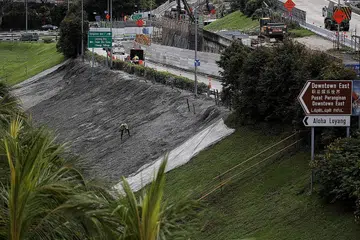 MENJALANI PEMBAIKAN: Siasatan awal menunjukkan bahawa kestabilan jalan raya tidak terjejas, kata LTA semalam. - Foto BH oleh JOEL CHAN