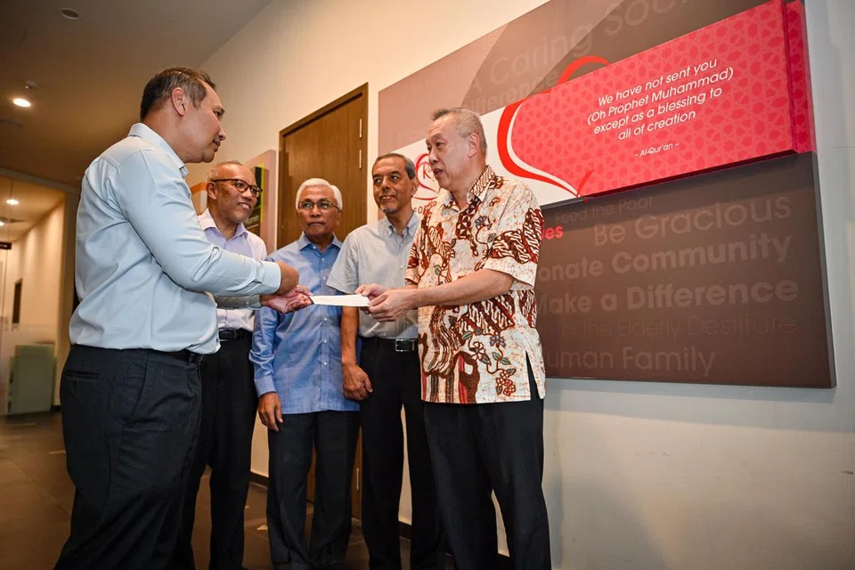 BERI SUMBANGAN: Ketua Pegawai Eksekutif (CEO) Sheng Siong Group Ltd, Encik Lim Hock Chee (kanan), menyampaikan cek kepada CEO RLAF, Encik Muhammad Faizal Othman (kiri), di Masjid Yusof Ishak pada Khamis. Majlis penyerahan cek itu turut disaksikan oleh wakil bukan pemastautin Singapura ke Palestin, Encik Hawazi Daipi (tengah); Pengerusi RLAF, Encik Abdul Razak Hassan Maricar (dua dari kanan); dan Timbalan Ketua Eksekutif Muis, Dr Albakri Ahmad (dua dari kiri).