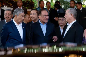 Perdana Menteri Malaysia, Datuk Seri Anwar Ibrahim (tengah), bersama Timbalan Perdana Menteri (TPM) I, Datuk Seri Dr Ahmad Zahid Hamidi (kiri), dan TPM II, Datuk Seri Fadillah Yusof (kanan), usai Majlis Perhimpunan Bulanan bersama Warga Jabatan Perdana Menteri di Putrajaya pada 5 Ogos.