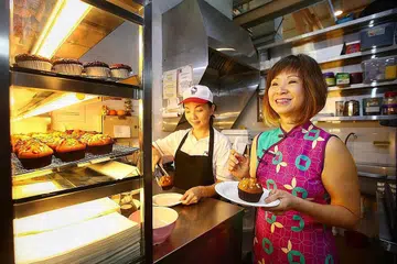 GERAI INKUBASI: Dr Amy Khor menemui Cik Tan Pey See, 44 tahun, seorang pegerai yang menjual mufin di Pusat Makanan ABC Brickworks semalam. Cik Tan antara mereka yang menyewa gerai di bawah Program Gerai Inkubasi. - Foto BH oleh GAVIN FOO