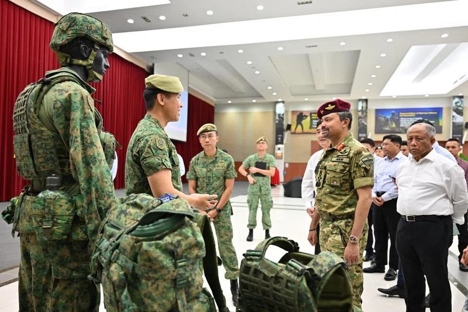 Putera Mahkota Brunei, Putera Al-Muhtadee Billah (beret merah), diberi taklimat tentang peralatan peribadi askar Angkatan Bersenjata Singapura (SAF).