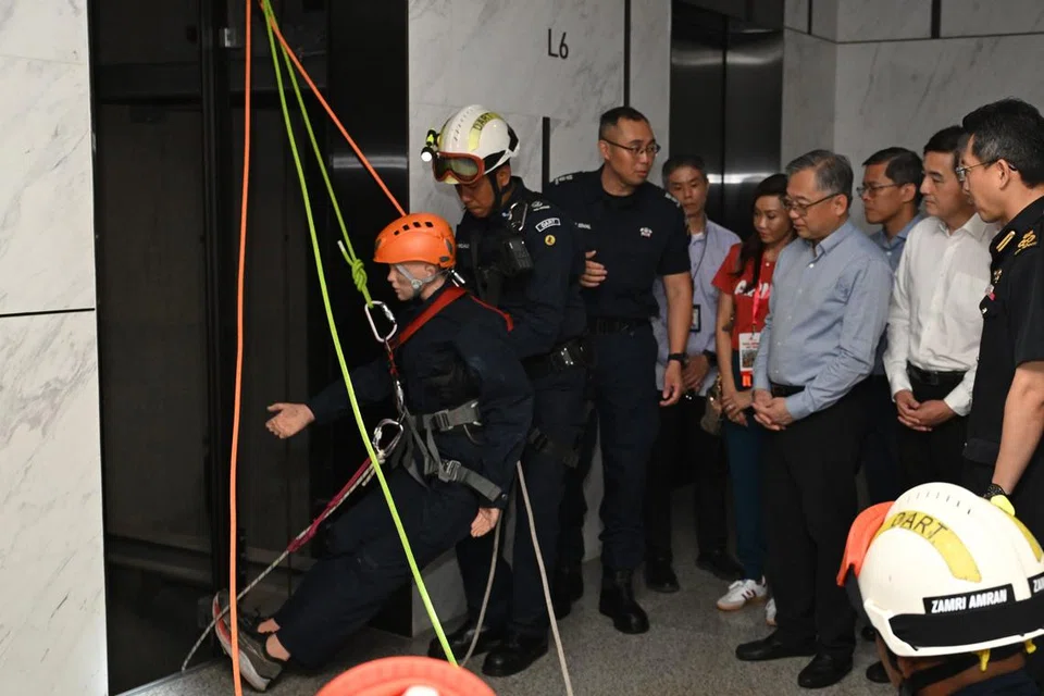 Timbalan Perdana Menteri (DPM) merangkap Menteri Perdagangan dan Industri, Encik Gan Kim Yong (tiga dari kanan) mendengar taklimat seorang pegawai semasa latihan serangan pancingan data (phishing) yang diadakan oleh Nexus dan Persekutuan Perniagaan Singapura (SBF). 