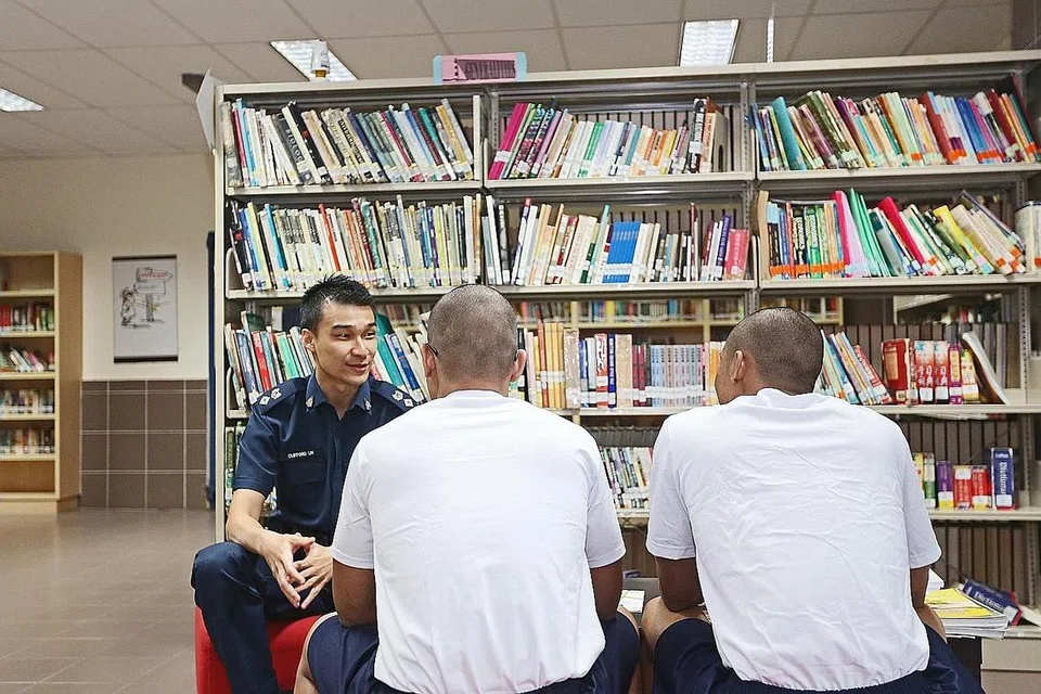 JALANI LATIHAN PEMULIHAN: 'Adam' dan 'Irfan' diarah menjalani hukuman di Pusat Latihan Pemulihan (RTC) Penjara Tanah Merah setelah terlibat dengan jenayah pada usia yang muda. Bersama mereka ialah Pegawai Bertanggungjawab bagi Unit Perumahan, RTC, Penjara Tanah Merah, Timbalan Superintenden Penjara (DSP) Clifford Lin. - Foto LIANHE ZAOBAO