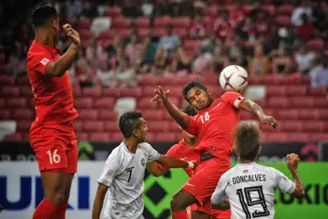 REBUT BOLA: Hariss Harun (dua dari kanan) sedang berebut bola dengan pemain Timor Leste malam kelmarin. Singapura berjaya membenam Timor Leste 6-1. - Foto BH oleh ARIFFIN JAMAR