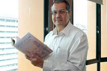 HARAP LEGASI BERKEKALAN: Encik Gamal Angullia berharap buku 'Indian Muslims in Singapore: History, Heritage and Contributions' mendorong anak-anaknya dan keluarga Angullia lain mencontohi cici-ciri seperti bekerja keras serta bijak melabur dan berniaga demi meneruskan legasi dermawan nenek moyang mereka. - Foto BH oleh KHALID BABA