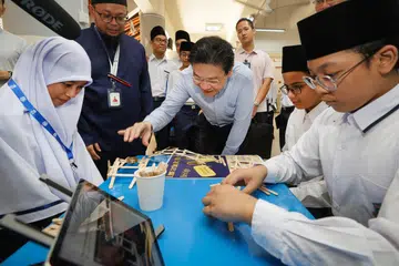 Perdana Menteri Encik Lawrence Wong (tengah) bertemu dan berinteraksi dengan pelajar Madrasah Aljunied Al-Islamiah.