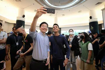 PERKASA BELIA: Encik Wong bersama Encik Syafiq memetik gambar 'wefie' bersama di Sidang Kemuncak Mentoring Kebangsaan 2022 di *SCAPE semalam. - Foto-foto BH oleh NG SOR LUAN, HAFIZ KASMAN