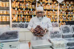 Pengasas dan pengerusi Al Barakah Beauty and Health Mart, Encik A Rahman Bahurudeen bersama pelbagai jenis kurma yang dijual di kedainya di Joo Chiat Road.